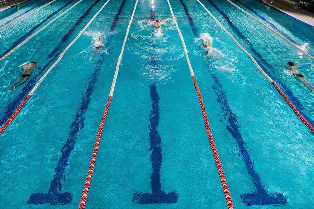 five-swimmers-racing-against-each-other-swiming-pool_171337-7818